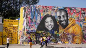 Fans gather around a mural of late NBA great Kobe Bryant and his daughter Gianna Bryant during a public memorial for them and seven others killed in a helicopter crash, at the Staples Center in Los Angeles