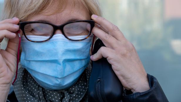 Woman with misted glasses due to protective mask